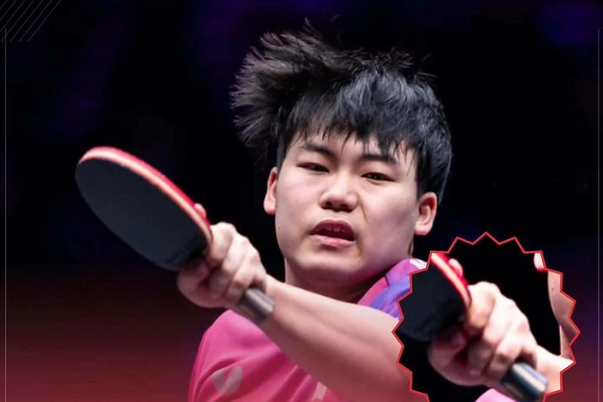 Sora Matsushima mid-stroke in a pink shirt with both hands on his racket