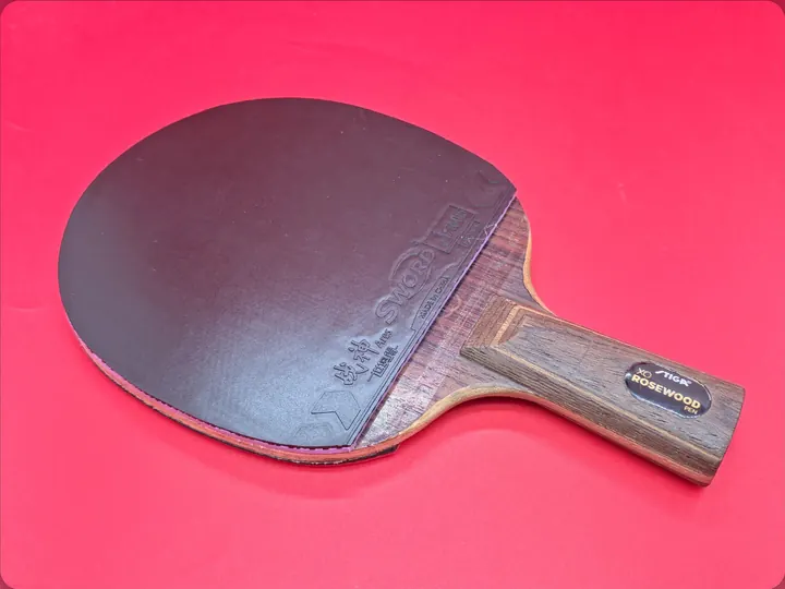 Stiga Rosewood XO penhold blade with SWORD Ares on the black face over its violet sponge and XIOM Vega Europe DF on the red