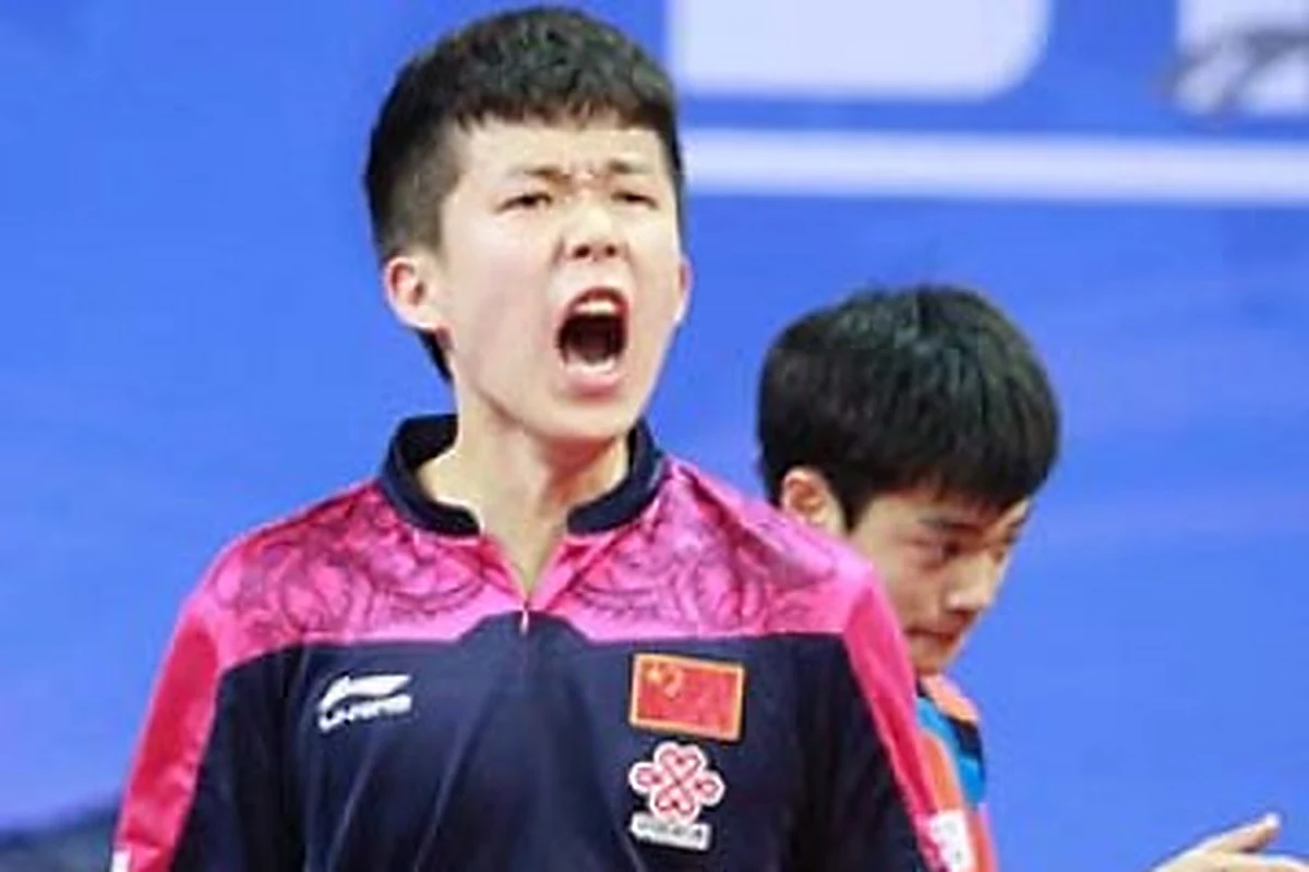Wang Chuqin shouting in his China shirt after a point
